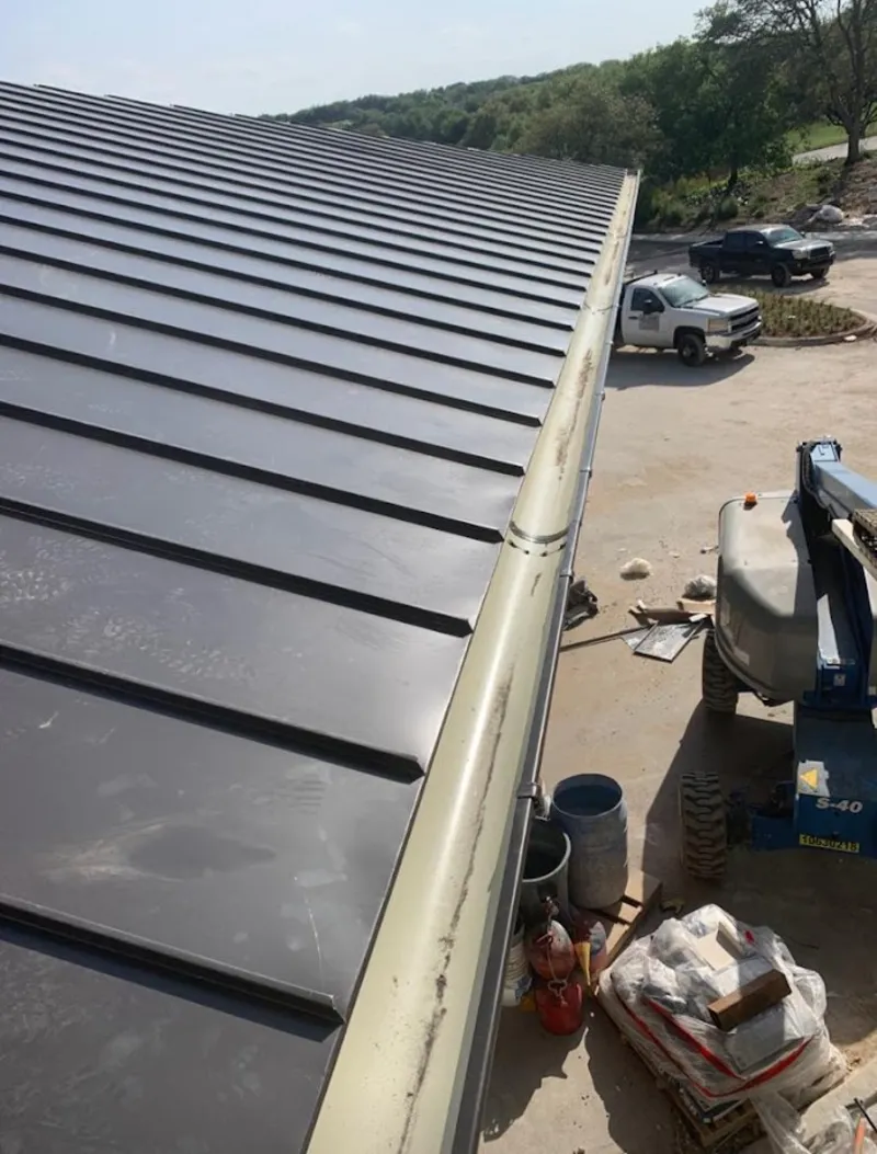 Standing seam panel and gutter detail on a metal roofing jobsite in West Haven